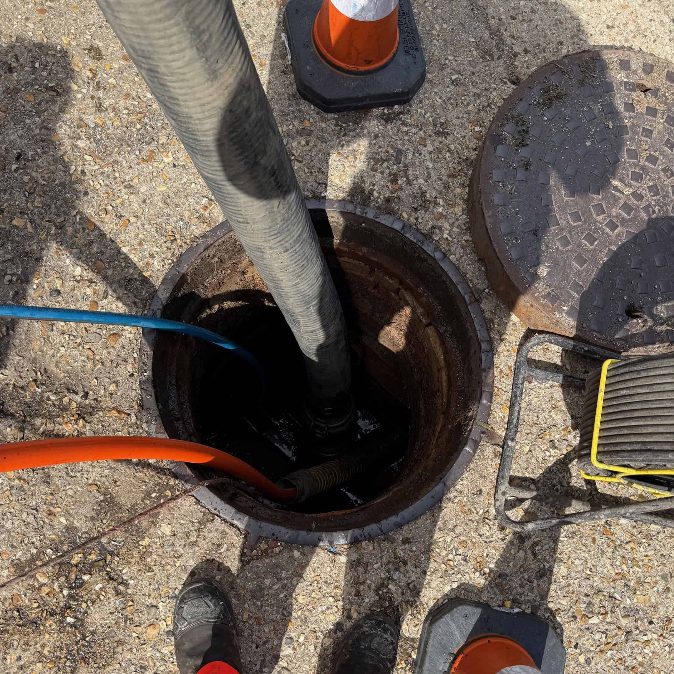 Underground drainage system being checked for blockages and repairs.